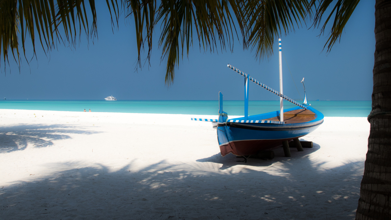 Лодка на белом песке у океана в тропиках