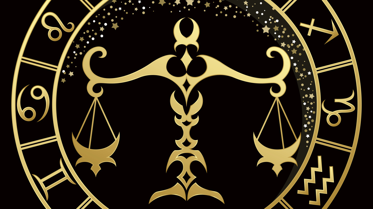 Золотой знак зодиака весы на черном фоне