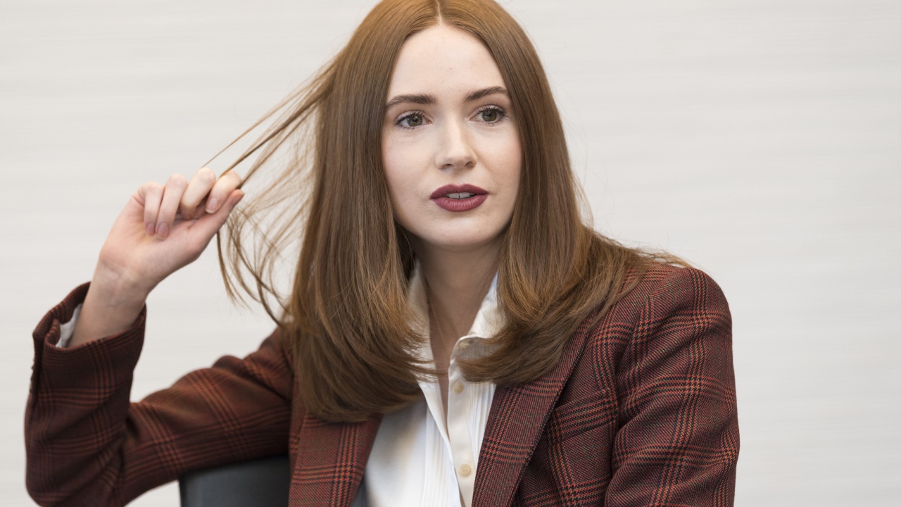 Актриса Карен Гиллан в пиджаке держит волосы