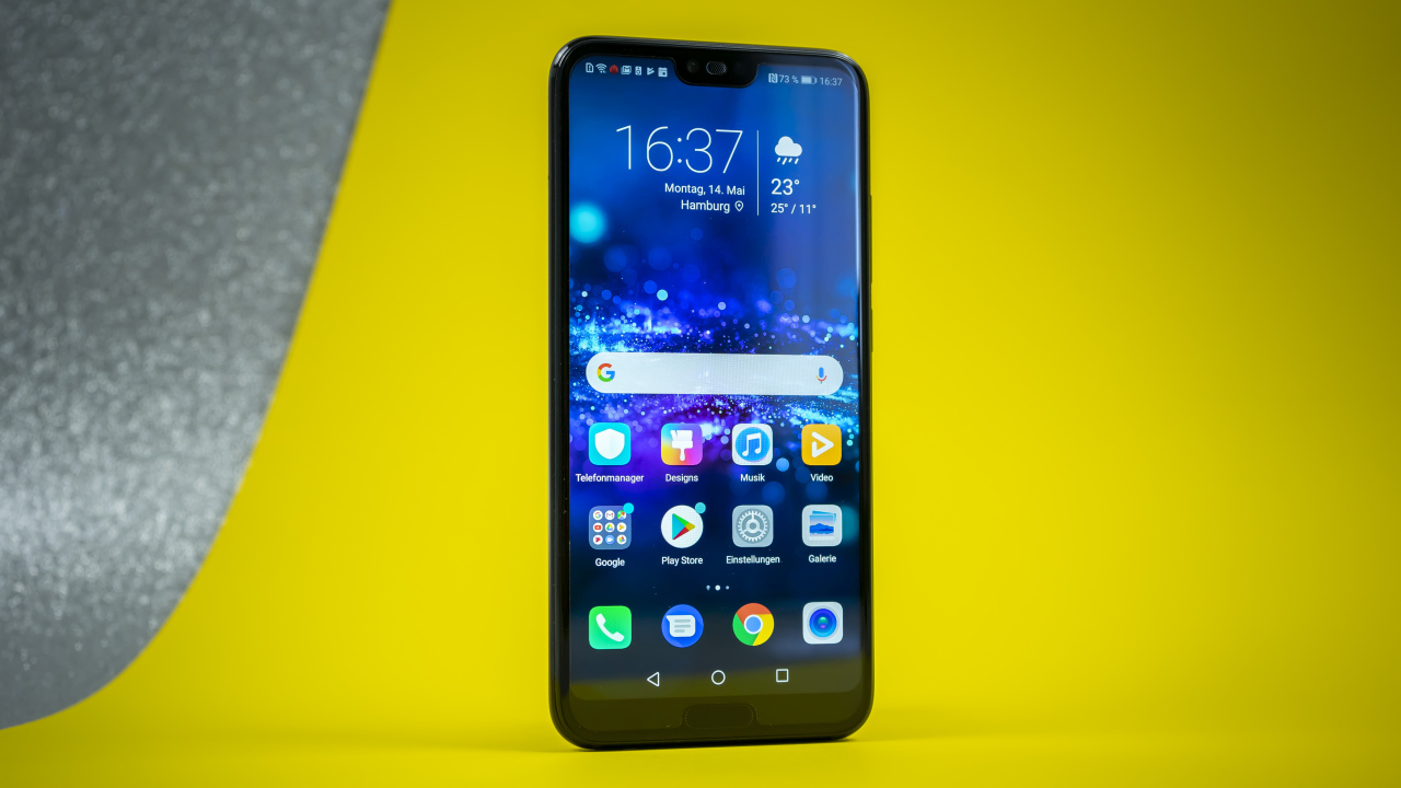 Тонкий смартфон Honor 10 на желтом фоне