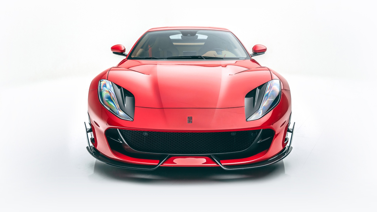Красный автомобиль Mansory Ferrari 812,  2020 года на белом фоне