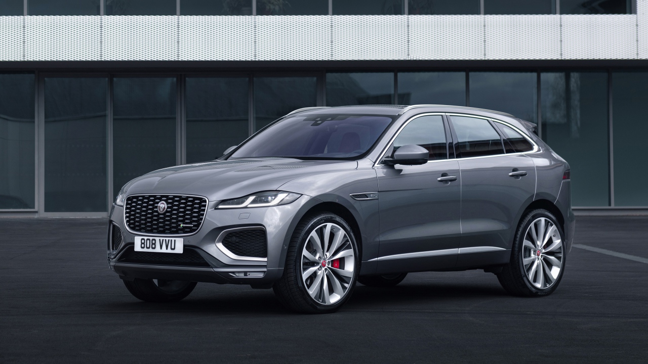 Серебристый автомобиль Jaguar F-Pace R-Dynamic 2020 года у здания 