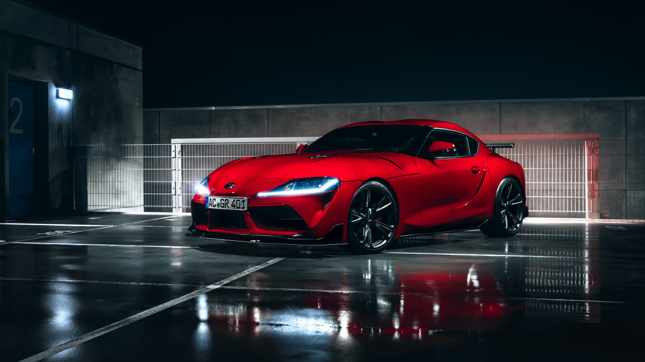 Красный автомобиль Toyota GR Supra AC Schnitzer 2019 года у гаража