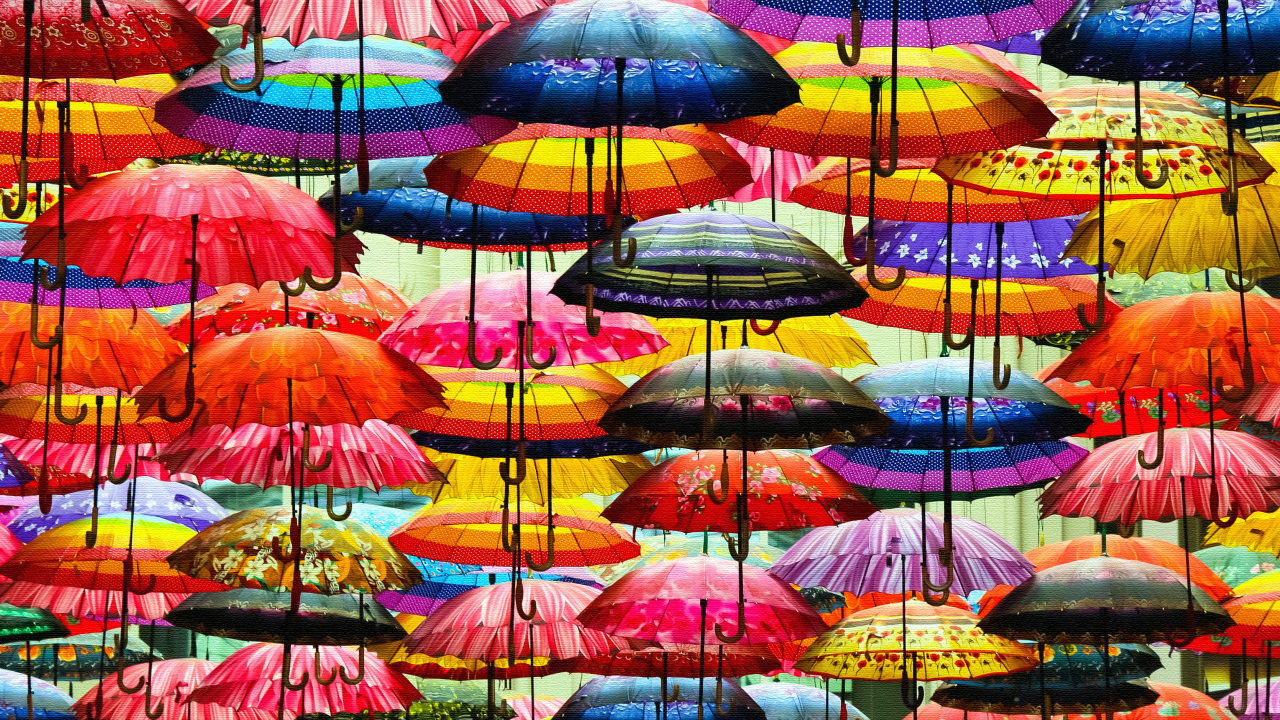 A lot of multi-colored umbrella in the air
