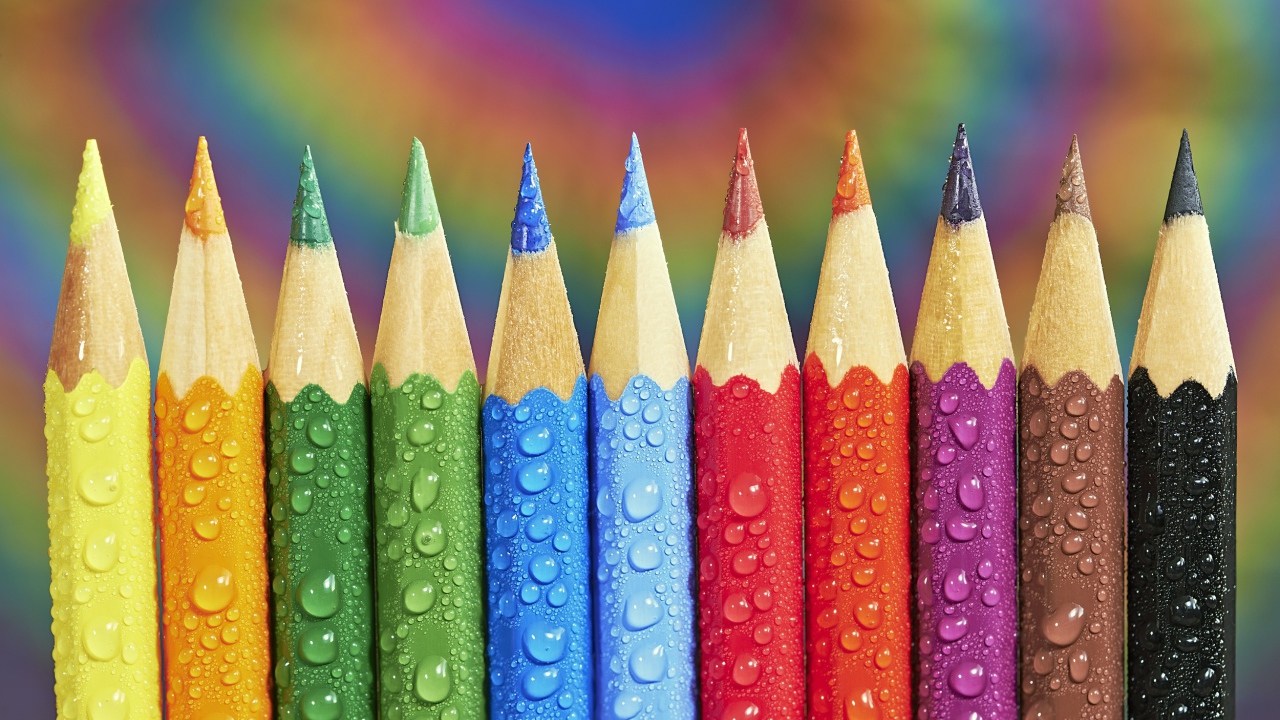 Заточенные разноцветные карандаши в каплях воды