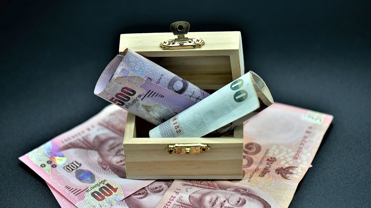 Paper money on gray background with wooden casket