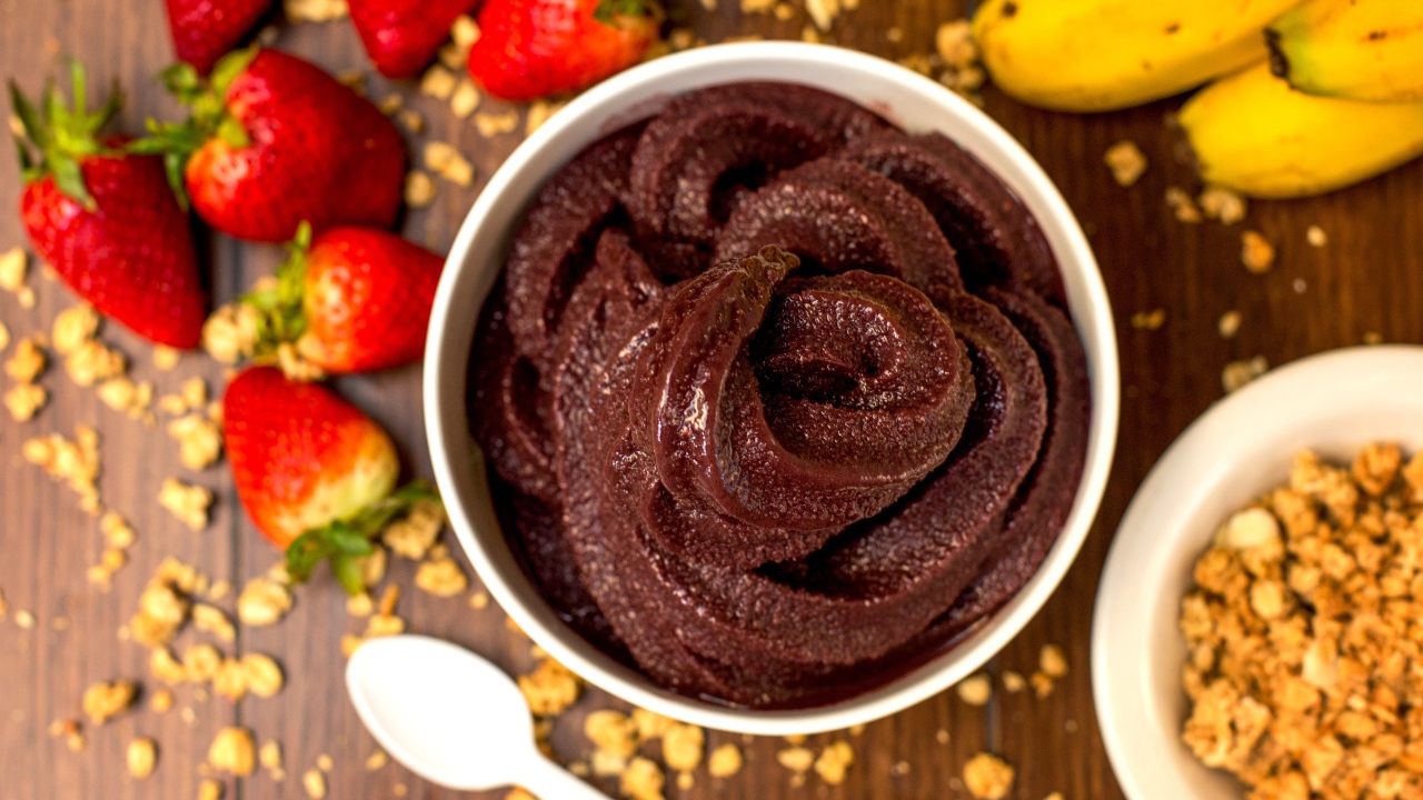Шоколадная паста на столе с ягодами клубники и бананами