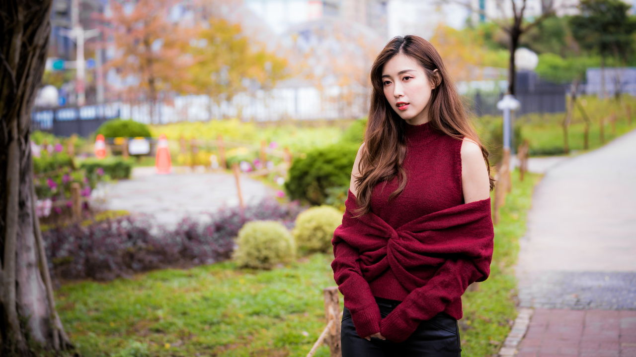 Красивая девушка азиатка в красном наряде в парке