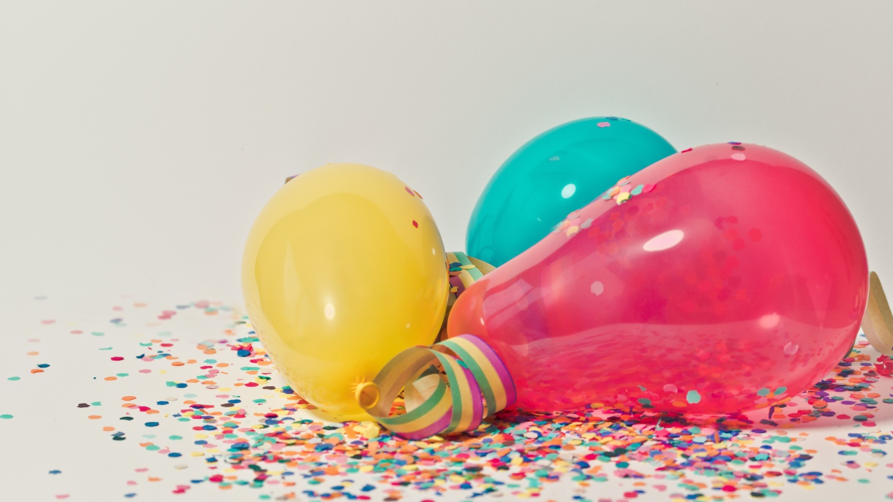 Balloons with confetti on gray background