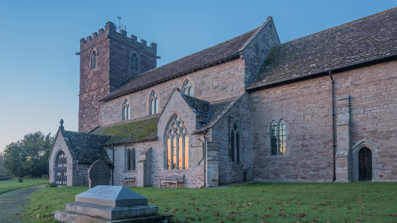 Старое каменное здание под голубым небом, Англия 