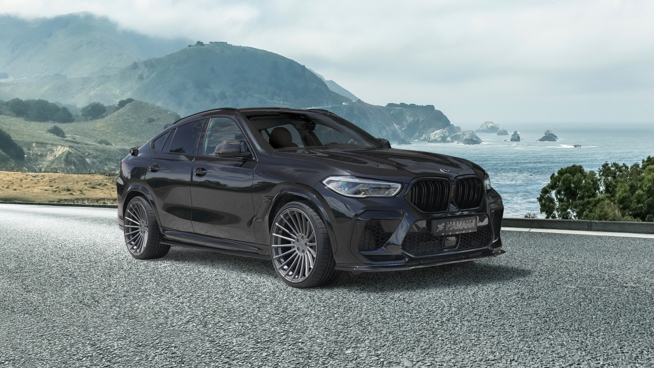 Черный автомобиль Hamann BMW X6 M Competition 2021 года на фоне гор