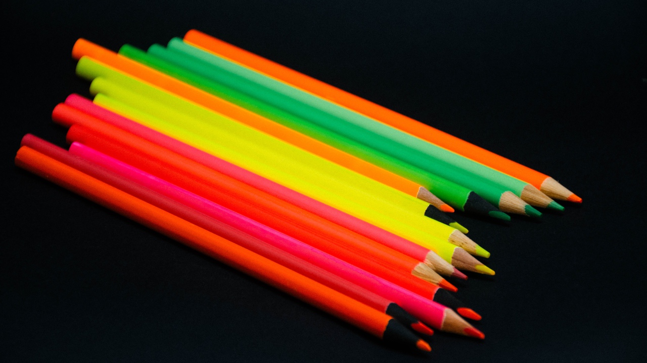 Палитра разноцветных карандашей на черном фоне