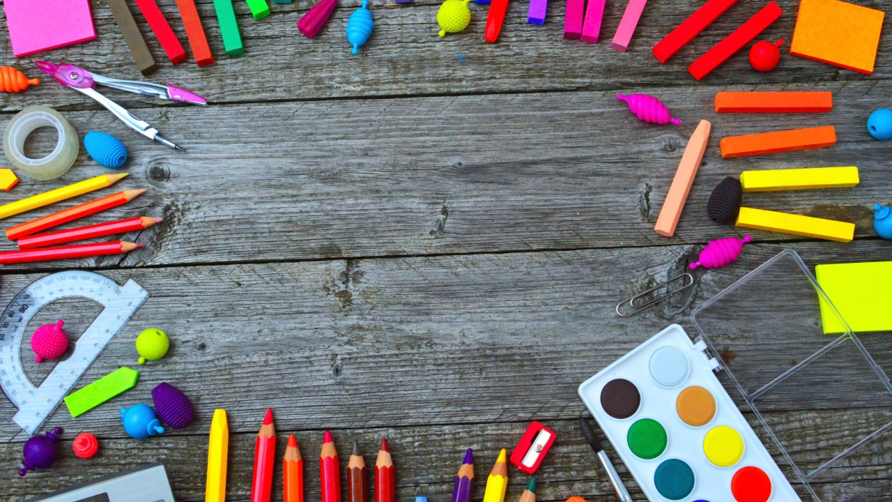 Радуга ярких канцелярских предметов для школы  на деревянном столе