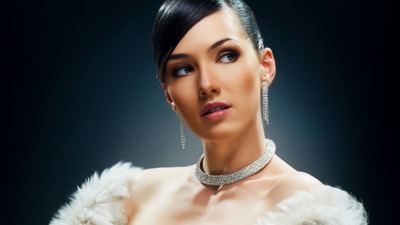 Красивая девушка с дорогими украшениями на черном фоне