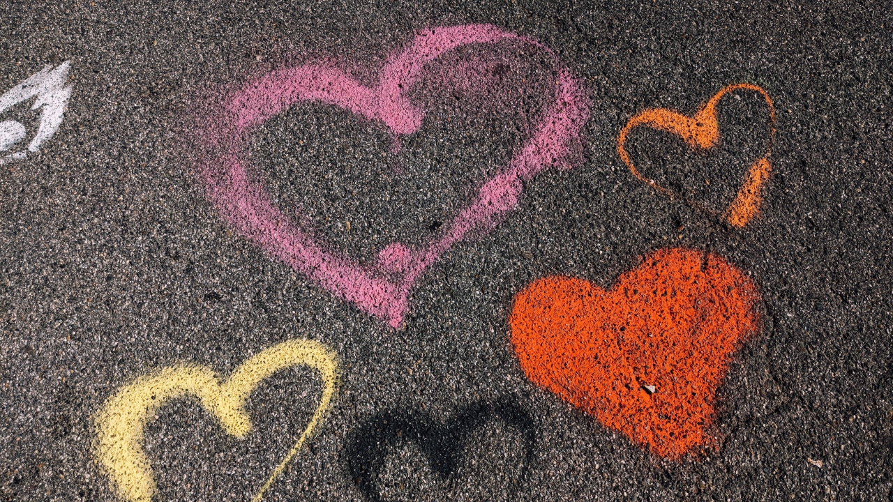 Сердечки разноцветным мелом на асфальте