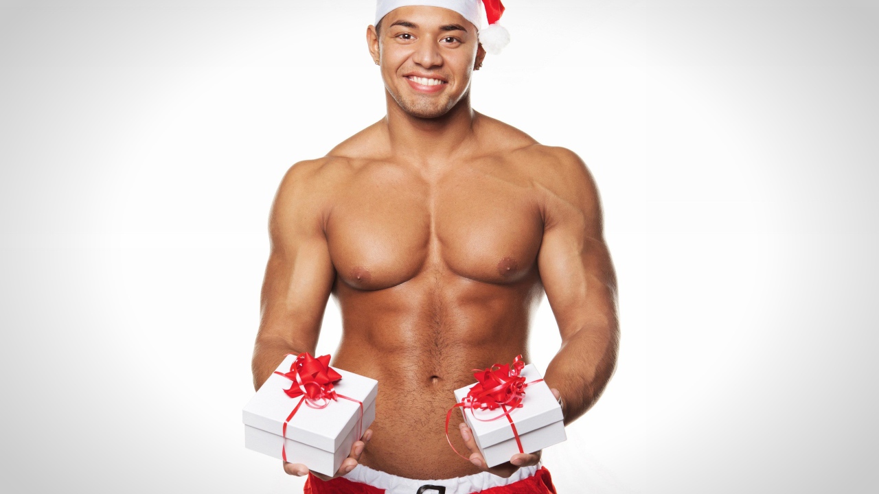 Накаченный мужчина в новогоднем костюме с подарками 