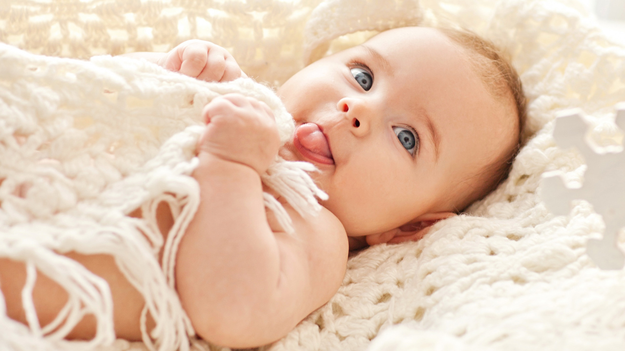 Забавный грудной ребенок с высунутым языком