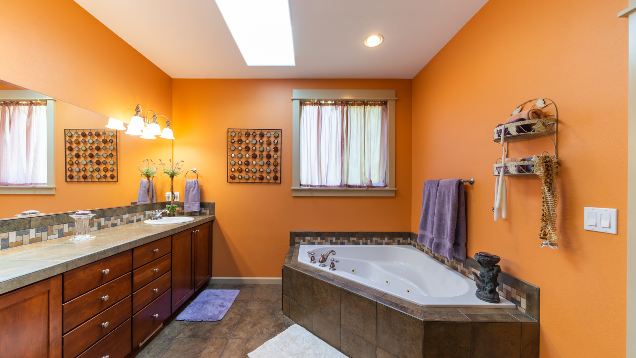 Большая ванная комната с оранжевыми стенами 