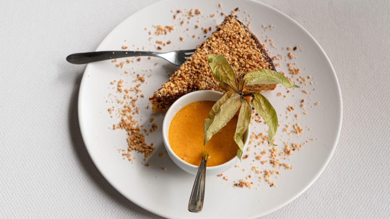 Кусок торта на белой тарелке с соком 