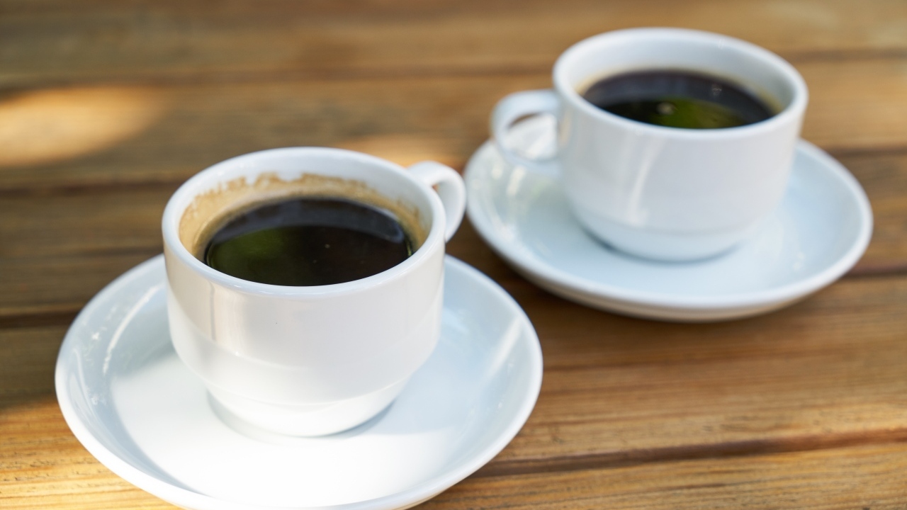 Две белые чашки кофе на столе 