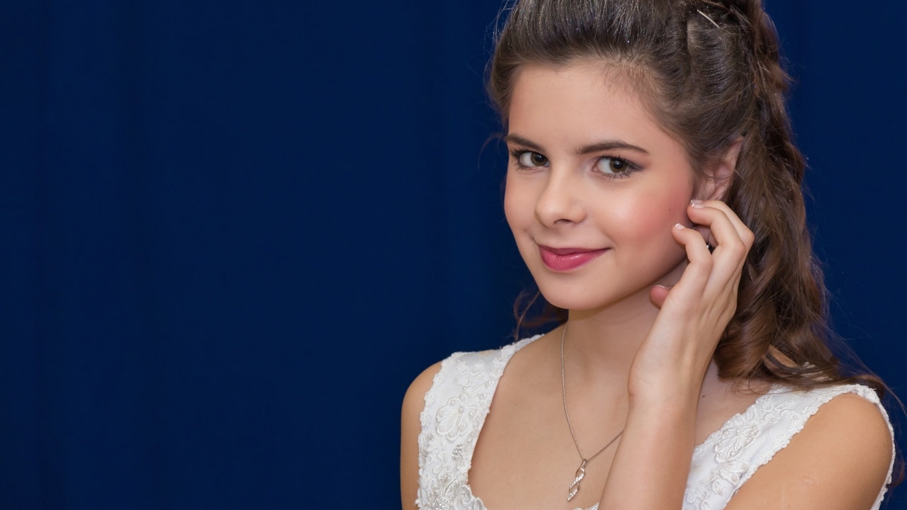 Милая девушка в белом платье на синем фоне