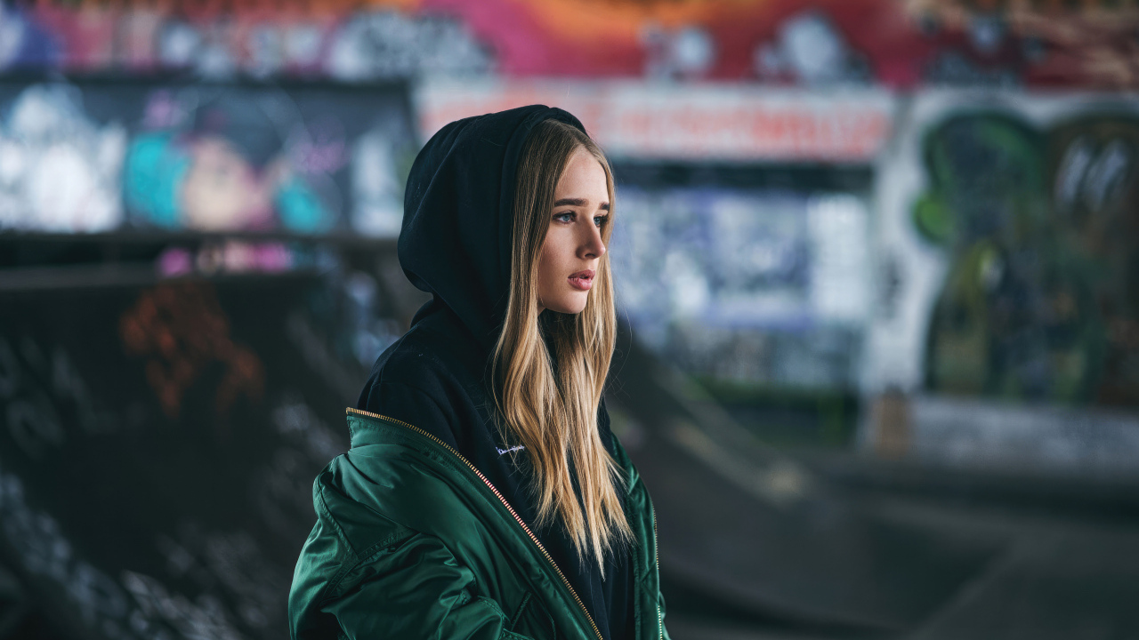 Молодая девушка в зеленой куртке