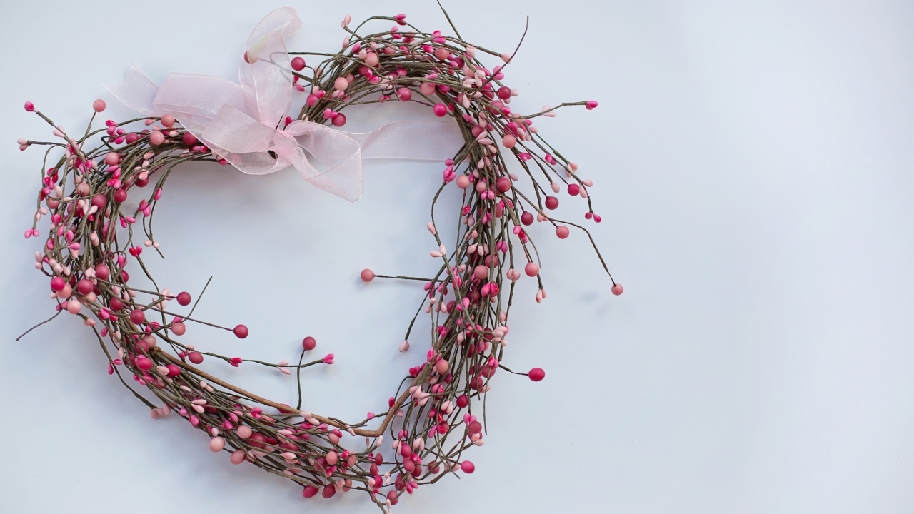 Heart from branches with a ribbon on a gray background