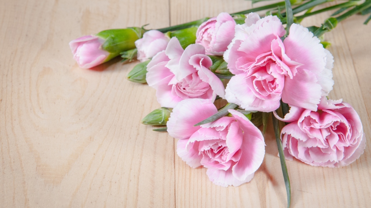 Розовые гвоздики на столе