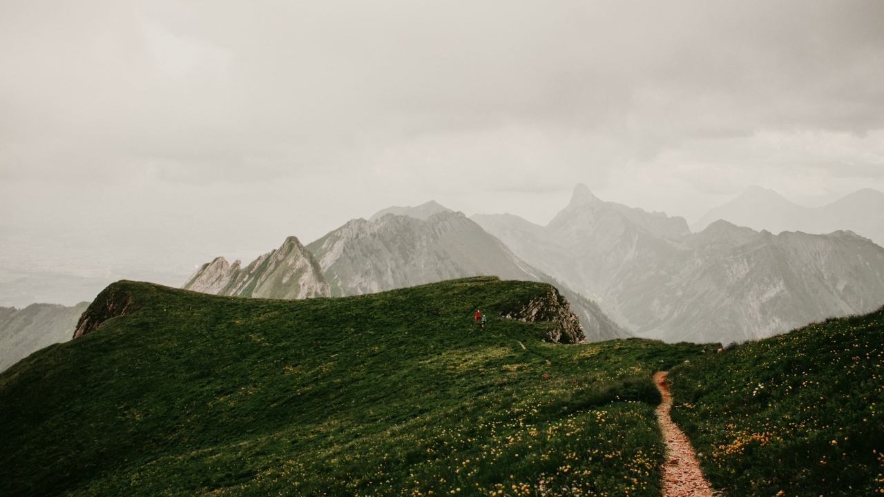 Тропа в покрытых зеленой травой горах