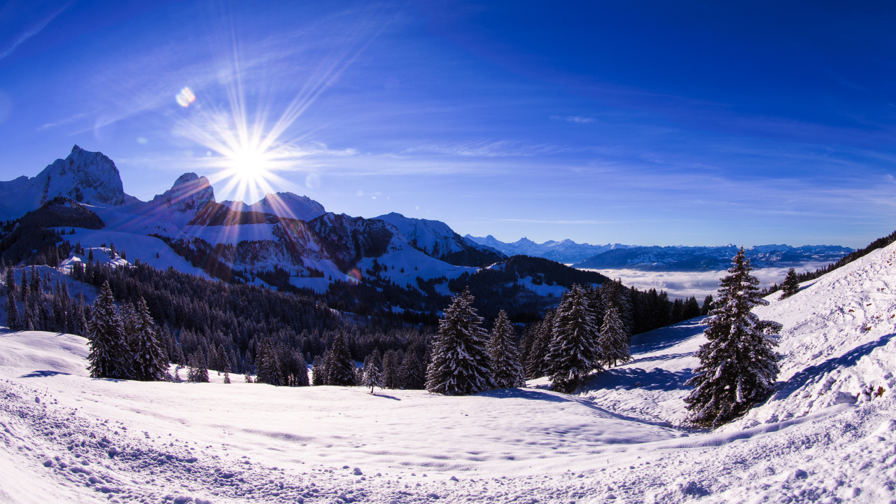 Яркое солнце освещает заснеженные альпы