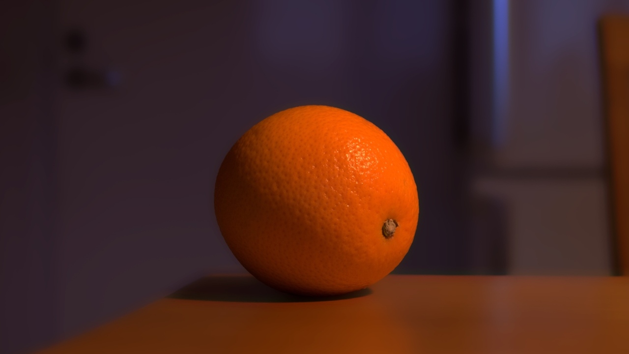 Один оранжевый апельсин лежит на столе