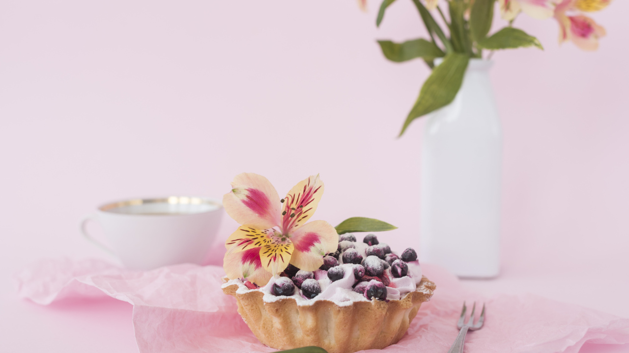 Черничное пирожное с цветами альстромерии на розовом фоне