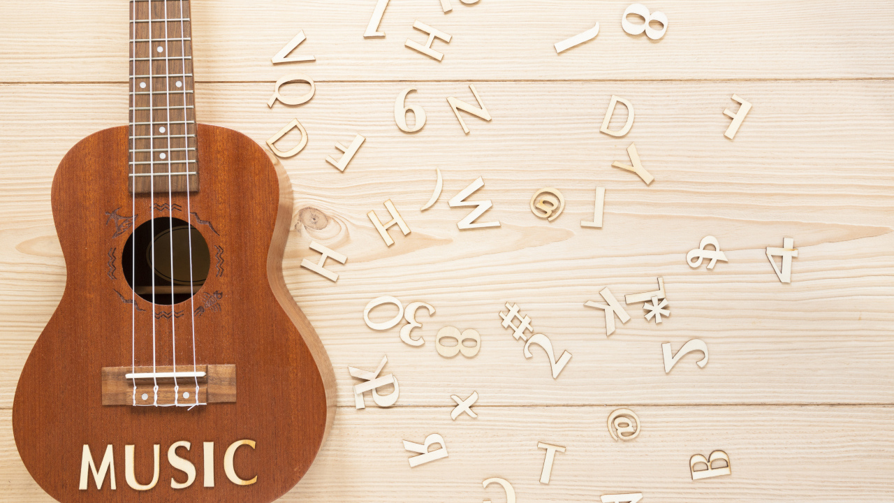Guitar on a table with wooden letters