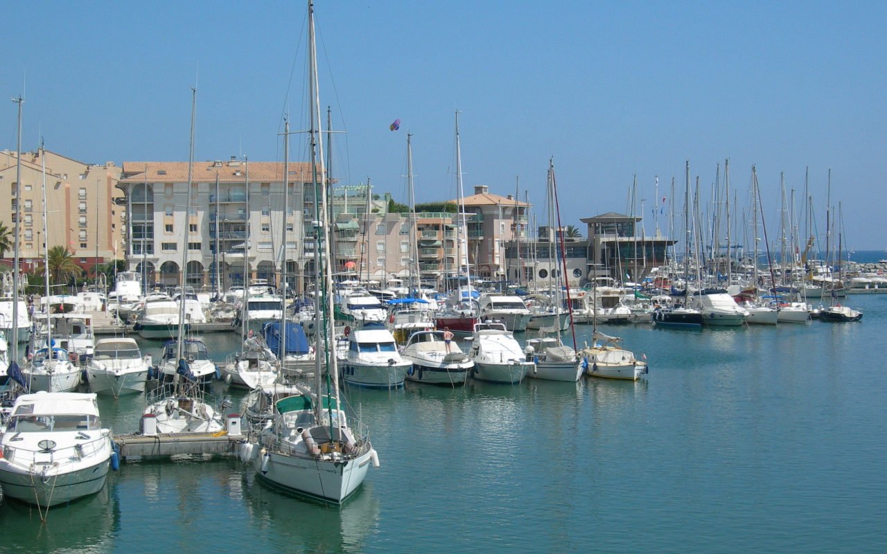 Яхты на фоне зданий на курорте Порт Де Фрежюс, Франция