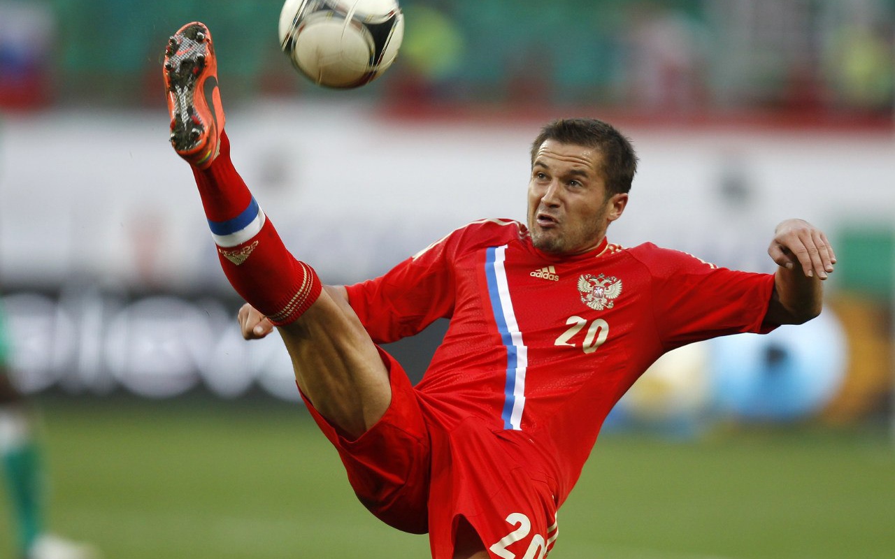 Полузащитник сборной России Виктор Файзулин бьет по мячу