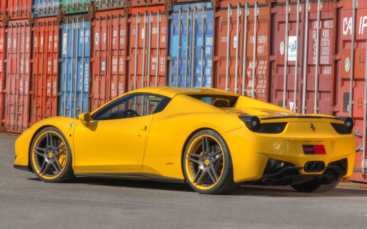 Yellow Ferrari 458 on a background of containers