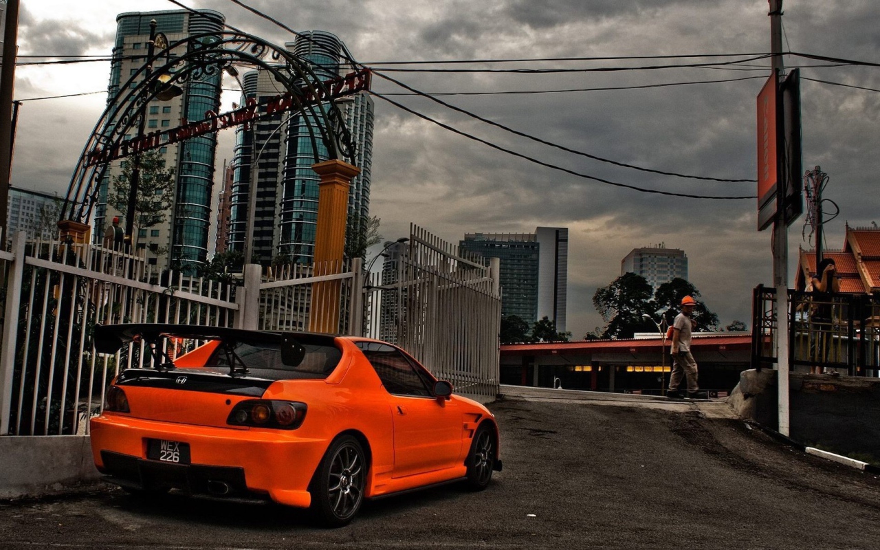 Orange Honda parked in the city