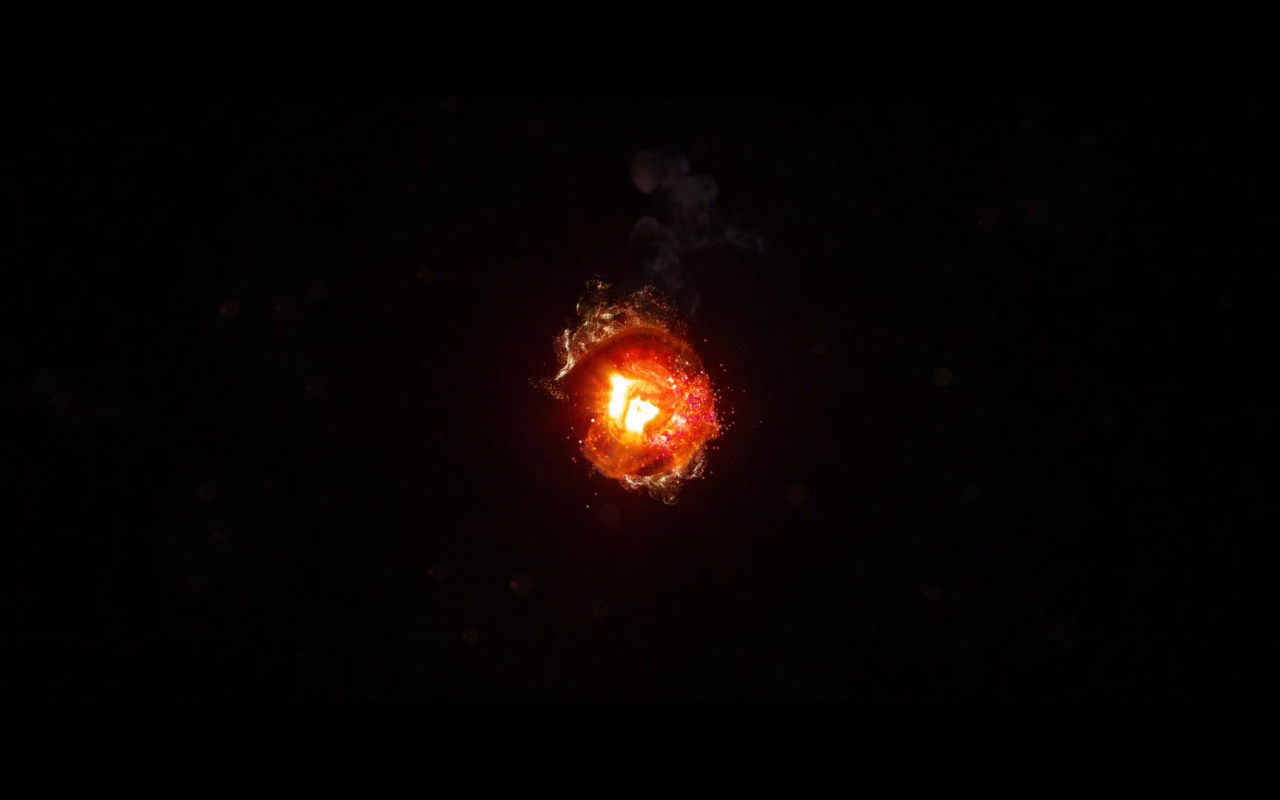 Горящий уголек, черный фон