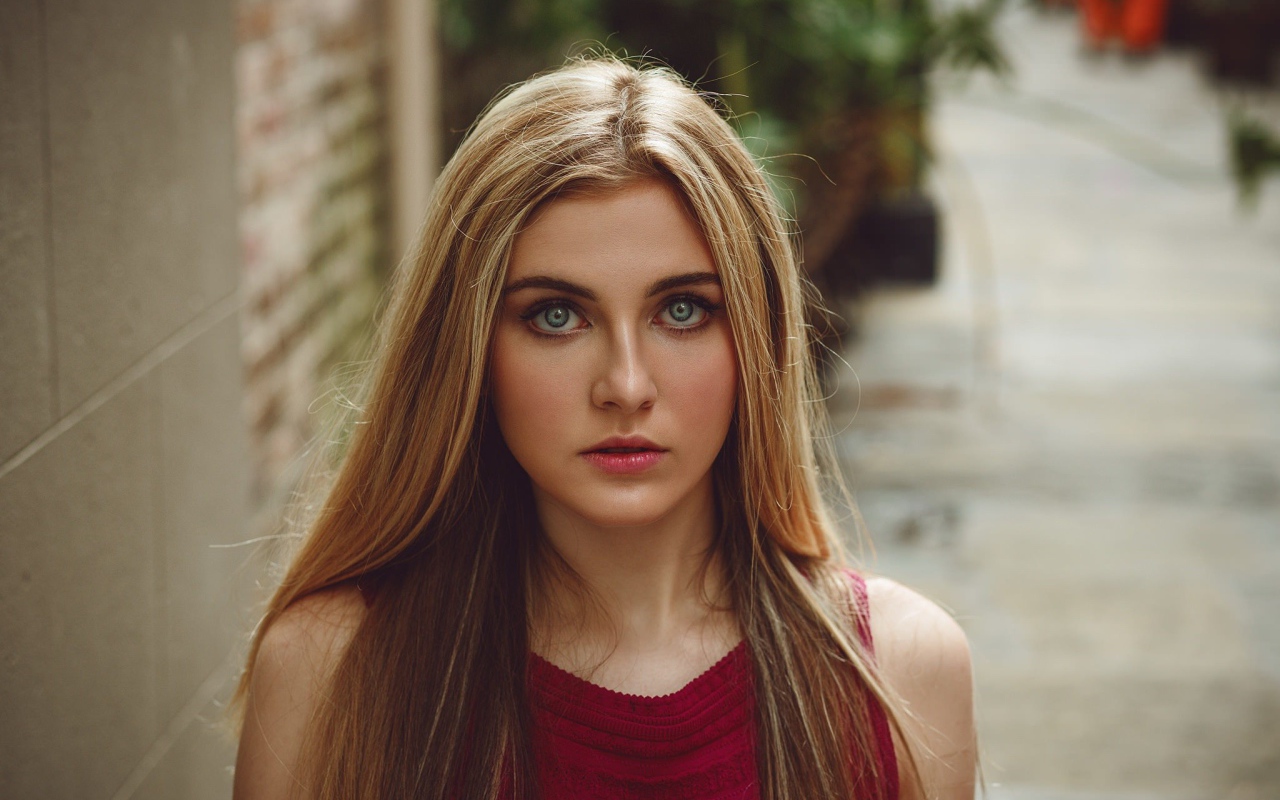 Блондинка с зелеными глазами идет по улице