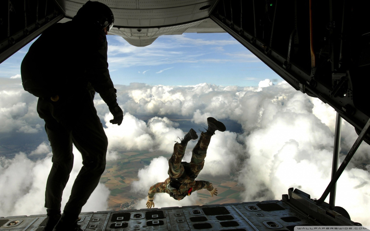 Paratroopers are jumping from an airplane