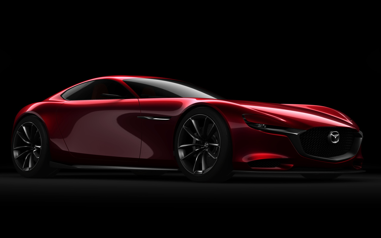 Красный спортивный автомобиль Mazda RX Vision Concept на черном фоне