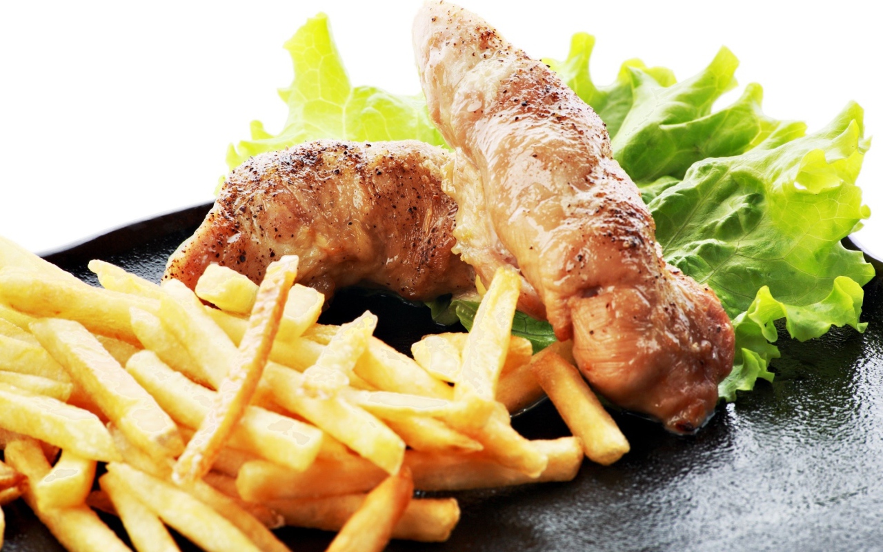 Куриные рулеты с картофелем фри и зелеными листьями салата