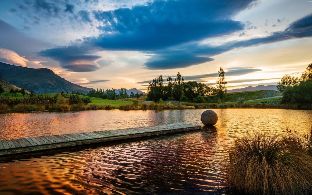 Деревянный мост в озере на закате солнца