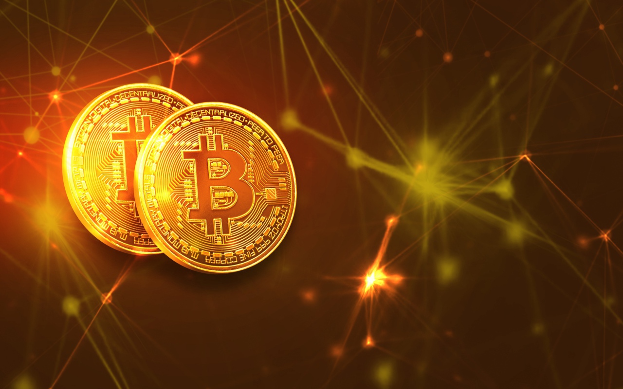 Two gold coins bitcoin against a background of virtual rays