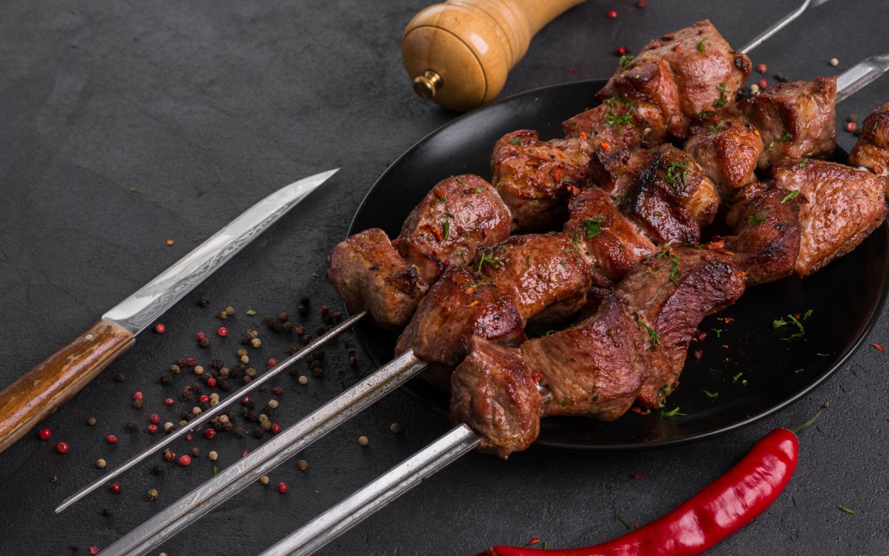 Аппетитный мясной шашлык на столе с перцем 