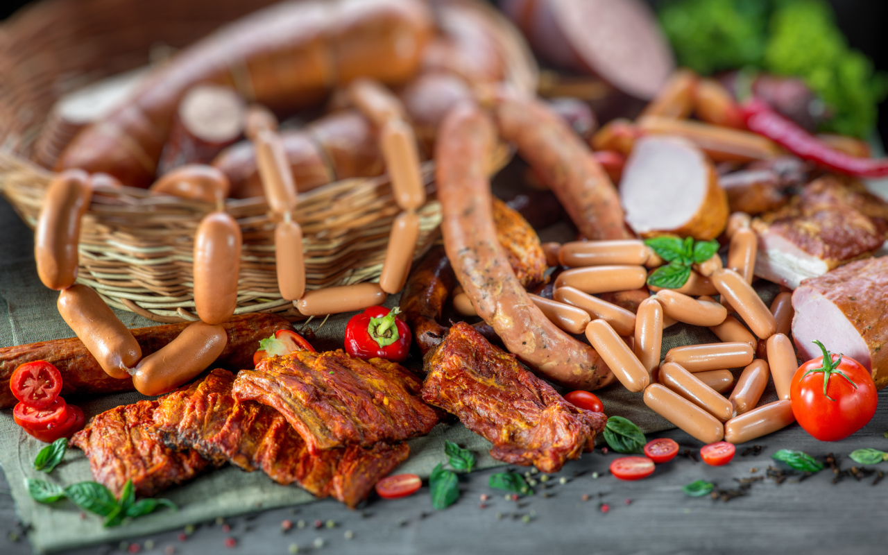 Копченые ребрышки с колбасой на столе 