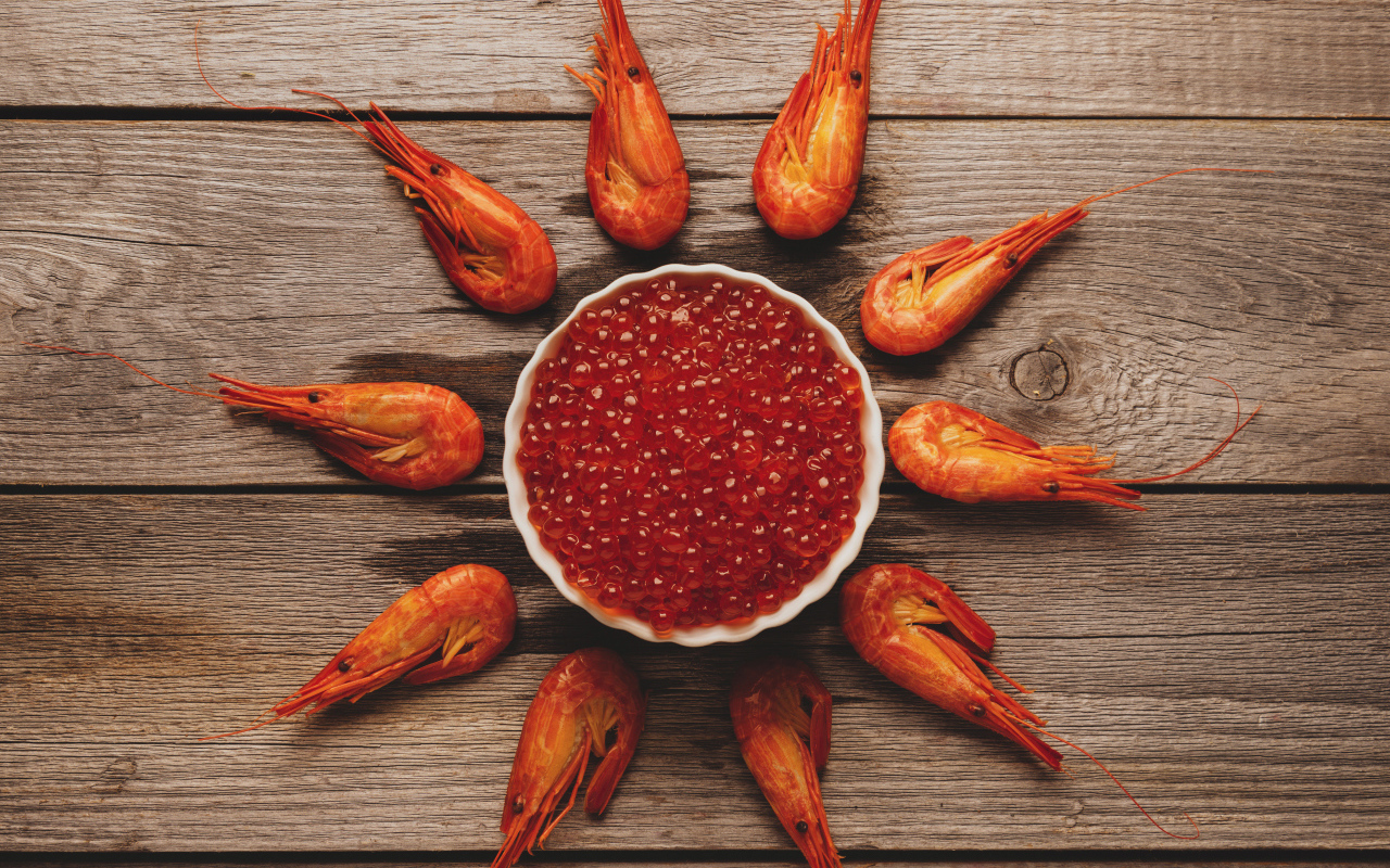 Вареные креветки на столе с красной икрой