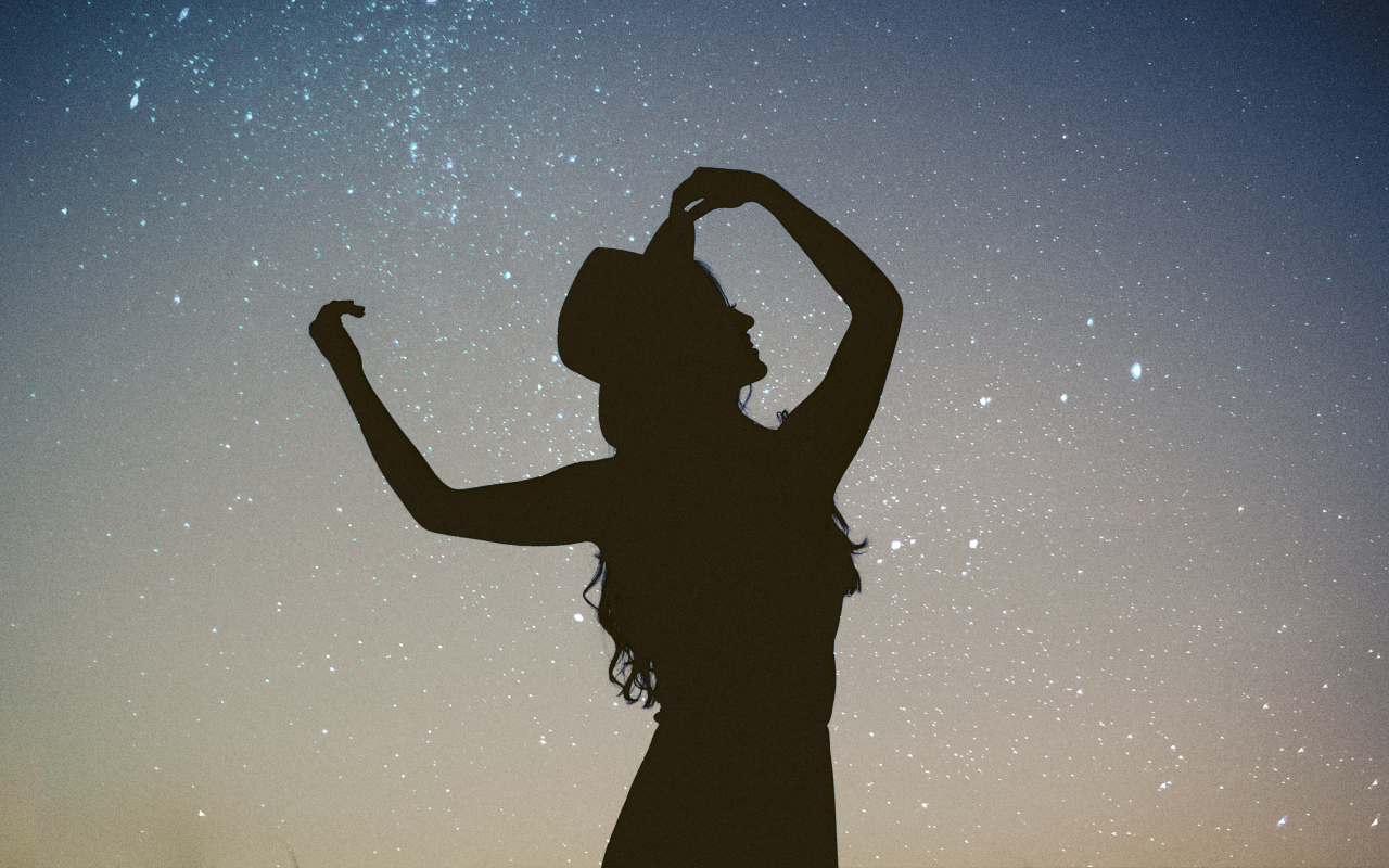 Силуэт девушки в шляпе на фоне неба