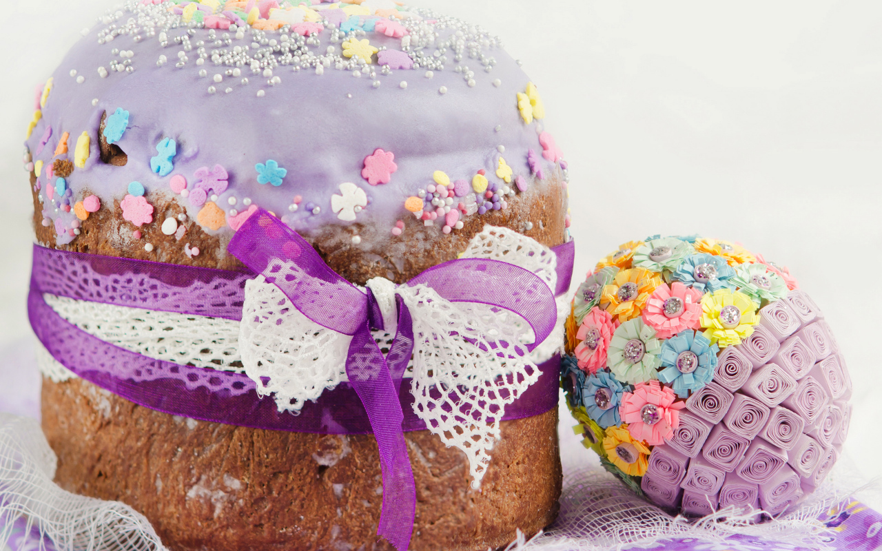 Красивый пасхальный кулич с лентой и декоративным яйцом на праздник Пасха