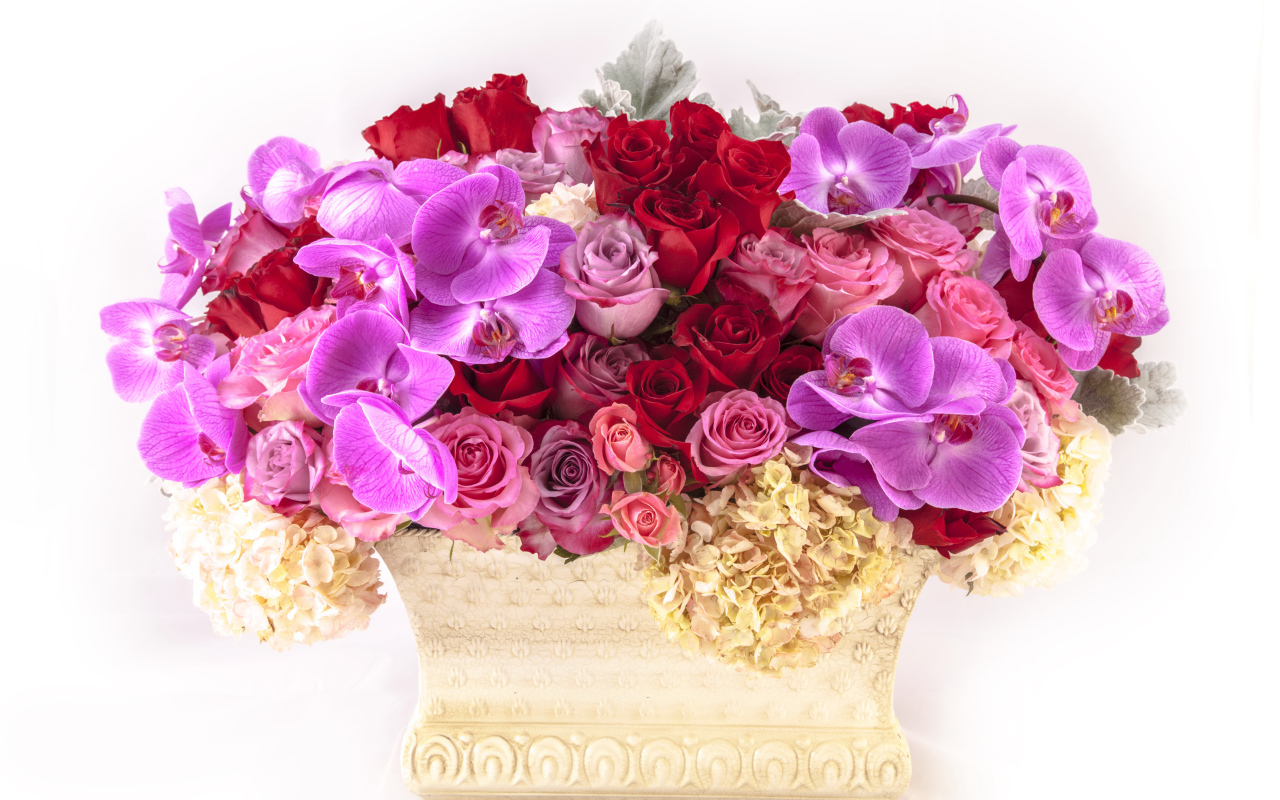 Basket with flowers of hydrangea, roses and orchids on a white background